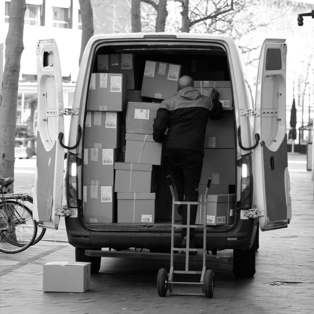 pexels-photo-11356987-11356987 Monochrome image of a man loading packages into a van outdoors in the Netherlands.